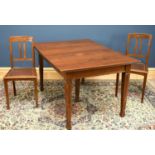 A set of six Edwardian carved oak dining chairs with a rectangular oak dining table, on tapered