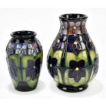 SALLY TUFFIN FOR MOORCROFT; two vases decorated in the 'Violet' pattern to include a baluster shaped