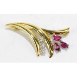 A yellow metal ruby and diamond set floral brooch, stamped 750 to the pin, length 3cm, approx weight