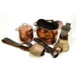 A collection of assorted metalware to include large Eastern cow bells, a copper twin handled