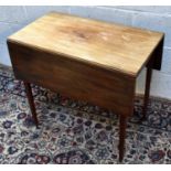 A 19th century drop leaf table, on tapered legs.