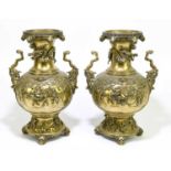 A pair of Chinese cast bronze vases, cast in high relief with scenes against a ground of clouds,