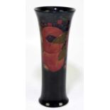 MOORCROFT; a 'Pomegranate' pattern vase, decorated in shades of red, blue, green and ochre against a
