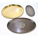 HUGH WALLIS; three Arts and Crafts trays comprising a circular brass example, diameter 46cm, an oval
