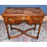 A walnut three drawer side table, height 80cm, width 93cm, depth 50cm.