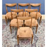 A set of six mid century teak dining chairs, with leather seats on tapered legs, height 80cm (6).