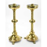 A pair of brass altar sticks, with twisted column, on claw feet, height 52cm (2).Condition Report: