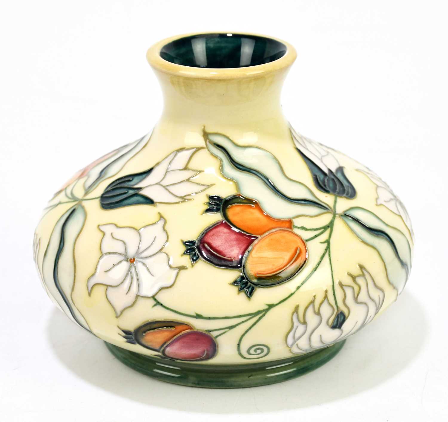 MOORCROFT; a squat vase decorated with floral sprays on an ivory ground, height 10cm.Condition