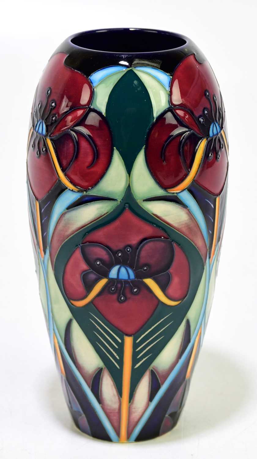 RACHEL BISHOP FOR MOORCROFT; a vase deorated with stylised flowers against a green goround, height