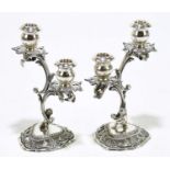 Two Continental 900 grade silver twin branch candle holders, each modelled as a kneeling boy