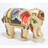 A Chinese ceramic model of an elephant, two impressed seal marks to the underside, length 22cm.