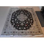 A modern Iranian Tabriz silk and wool/cotton rug with a geometric design, 205 x 145cm, with label to