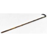 A bamboo walking stick with dark horn handle, the base containing a brass tipped rod measuring 75cm,