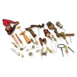 A collection of corkscrews and bottle tops to include an Austrian carved and painted wood bottle