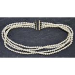A cultured pearl four row choker set with seven round brilliant cut diamonds to a yellow metal