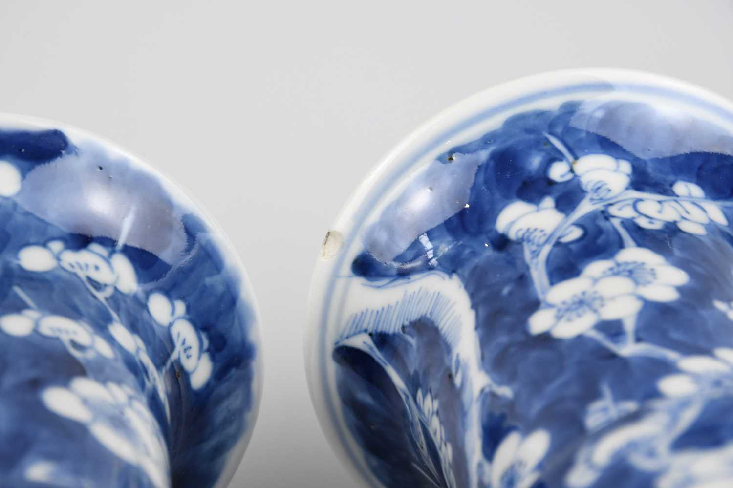 A pair of late 19th century Chinese blue and white porcelain Gu vases painted with prunus flowers on - Image 5 of 5