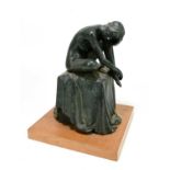 A mid century carved resin figure of a seated female nude on a square plinth, unsigned, on square