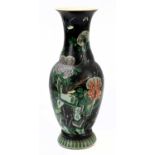 A Chinese Famille Noire baluster vase decorated with bird, butterflies, and floral sprays,