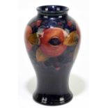 MOORCROFT; a 'Pomegranate' pattern vase, decorated with fruit and berries against a blue ground,
