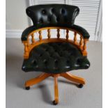 A modern Captain's stye office chair with green leather button back and seat.Condition Report: In