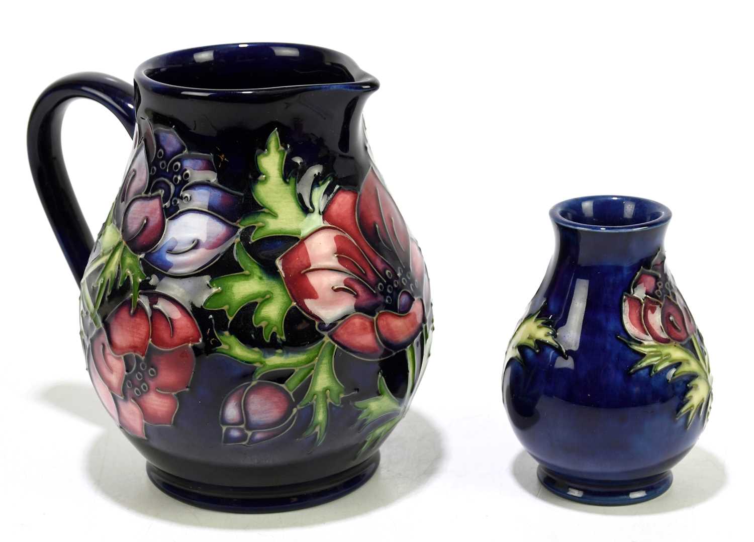 MOORCROFT; two pieces decorated in the 'Anemone' pattern, comprising a jug, height 15cm, and a squat