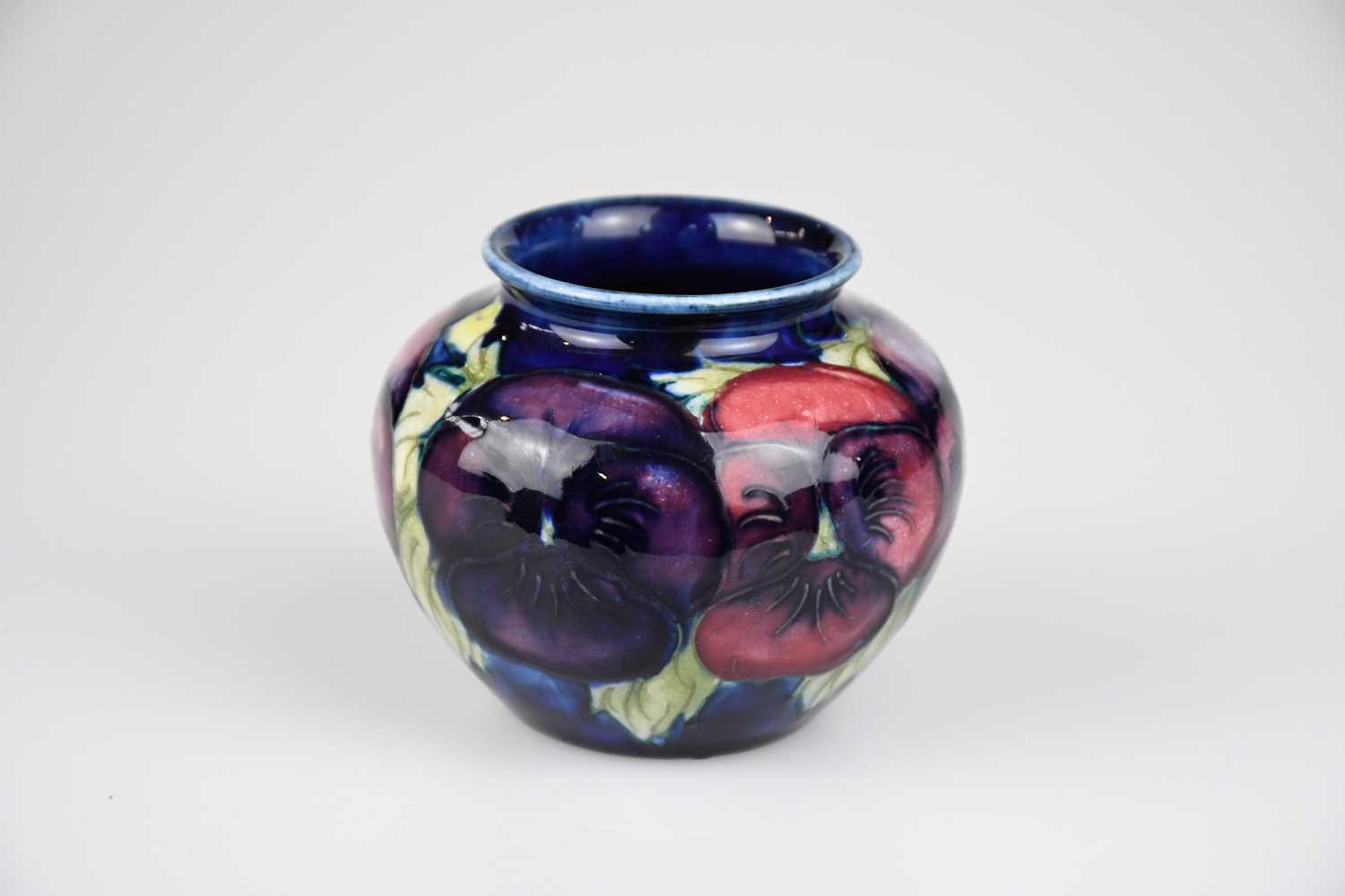 WALTER MOORCROFT; a squat vase in the 'Pansy' pattern on a blue ground, impressed marks to the - Image 2 of 4