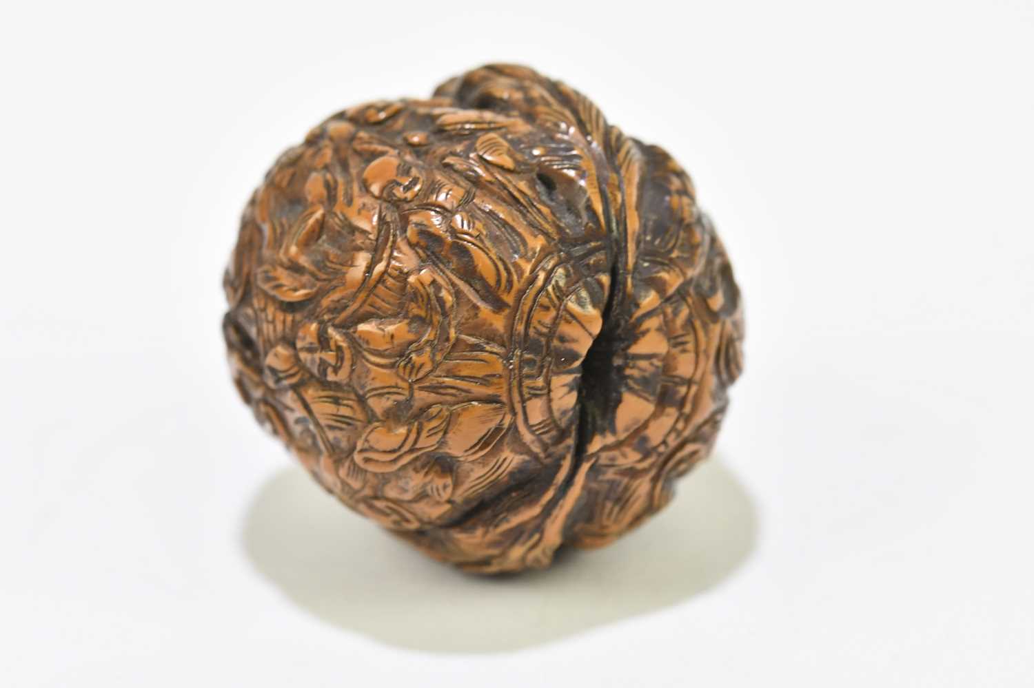 A Japanese carved walnut, decorated with figures within floral detail, height 3cm. - Image 2 of 4
