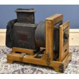 ABBEYVALE; an early 20th century oak and metal Magic Lantern projector, of large proportions, with