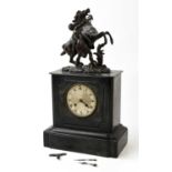 A 19th century slate mantel clock with bronze finial representing a Marly horse, the silvered dial