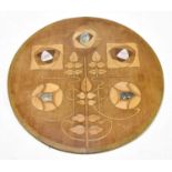 An Arts and Crafts mother of pearl and abalone inlaid panel of circular form, diameter 32cm.