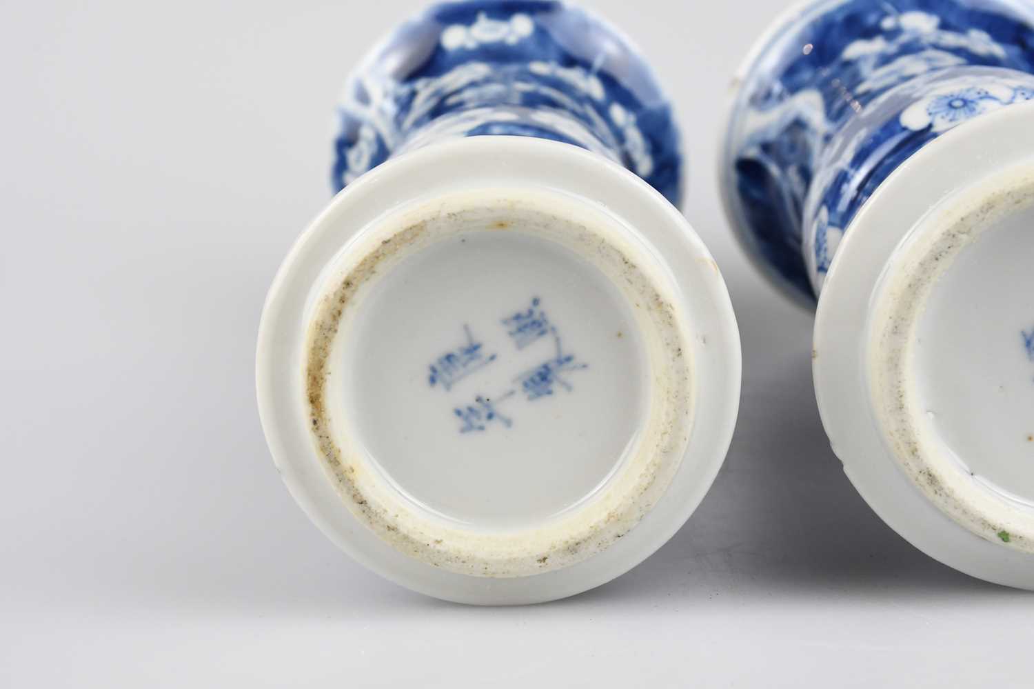 A pair of late 19th century Chinese blue and white porcelain Gu vases painted with prunus flowers on - Image 3 of 5