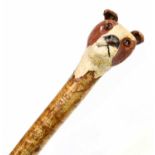 BOB WILLIAMS; a contemporary carved walking cane, the handle modelled as a dog's head with glass