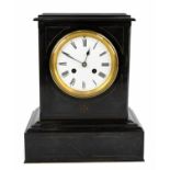 A Victorian black slate eight day mantel clock, the enamel dial with Roman numerals, a movement