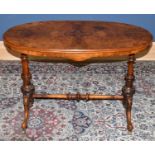 A Victorian inlaid walnut oval loo table, with turned and carved legs, height 72cm, width 106cm.