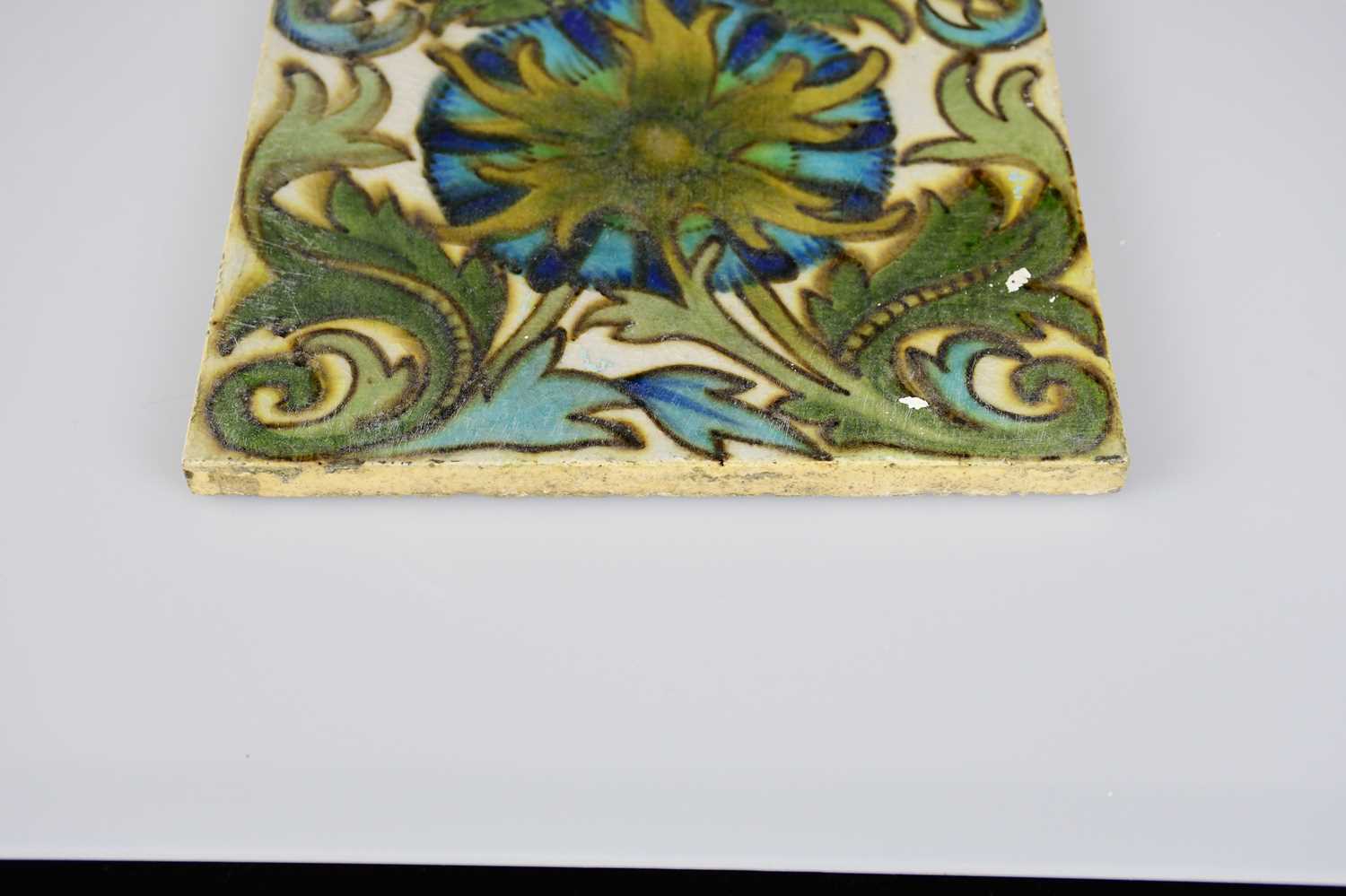 ATTRIBUTED TO MAW & CO; an Art Pottery tile painted with floral decoration, in shades of green, - Image 3 of 6