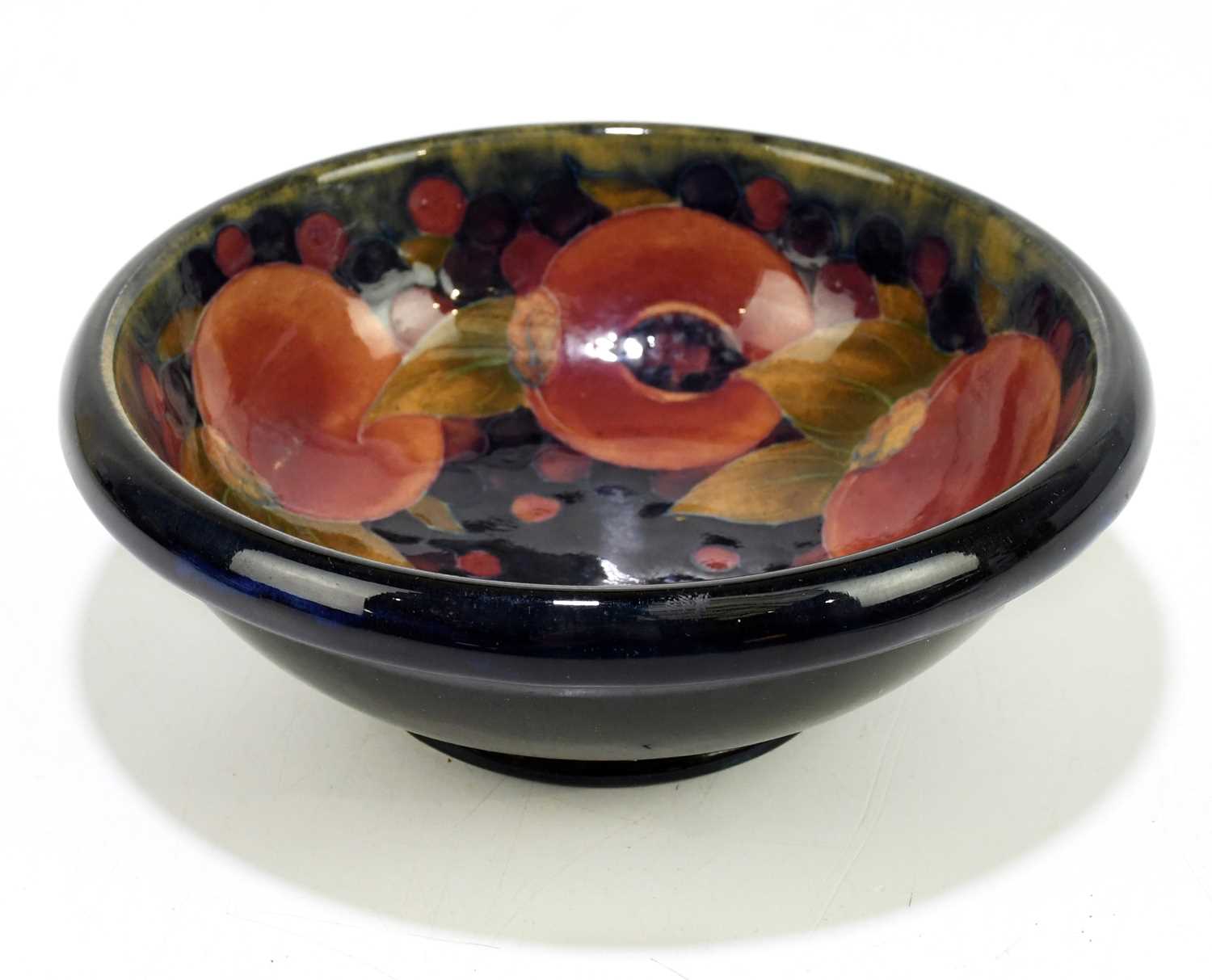 MOORCROFT; a 'Pomegranate' pattern bowl, with shaped rim, impressed marks and painted William