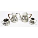 WILLIAM HUTTON & SONS, CUNNELL CHEAPSIDE; an English pewter four piece tea service comprising