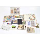 An assortment of British and world stamps, together with a small collection of postcards.