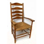 Attributed to Philip Clisset (1817-1913) an oak ladderback elbow chair with rush seat on turned