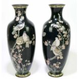 A pair of Japanese cloisonne vases decorated with birds in a blossom tree, each bears signature to