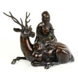 A 19th century Japanese bronze censer modelled as a sage holding a sceptre, seated upon the back