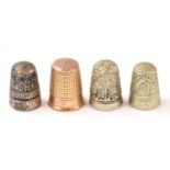 A 9ct gold thimble, together with three white metal examples.