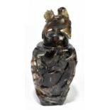 A Chinese carved agate vase and cover, the lift-off cover surmounted with a bird amongst a pierced