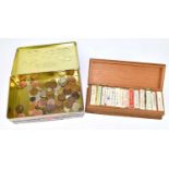 A wooden box containing a large quantity of assorted cigarette cards, with a small quantity of