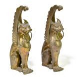 A pair of bronzed metal terminals representing mythical creatures with scrollings wings, height 31cm