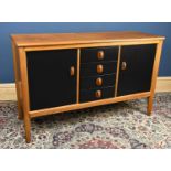 GORDON RUSSELL; an oak sideboard with four later painted drawers flanked by two panelled cupboard