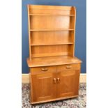 An Ercol type light oak dresser, with three tier plate rack back above two drawers and two