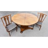 X A mid century rosewood circular draw-leaf dining table with additional leaf, on octagonal fluted