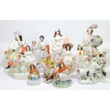 Eleven Staffordshire porcelain figures to include woman holding a basket with birds in it, a young