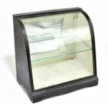 An early 20th century black painted chocolate display cabinet of small proportions with shaped glass